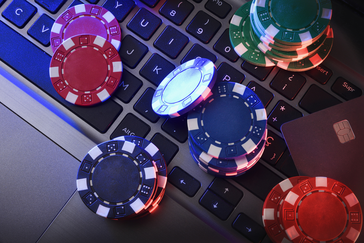 Betting Online Games With Chips On Laptop Keyboard And Card