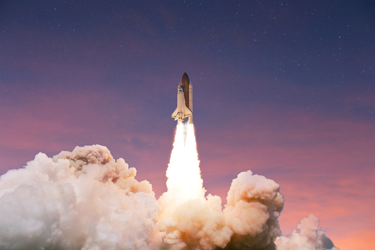 Successful Launch Of A Rocket Into Space At Sunset. Spaceship Takes Off Up Into The Pink Blue Sky. Launch Startup Business, Concept