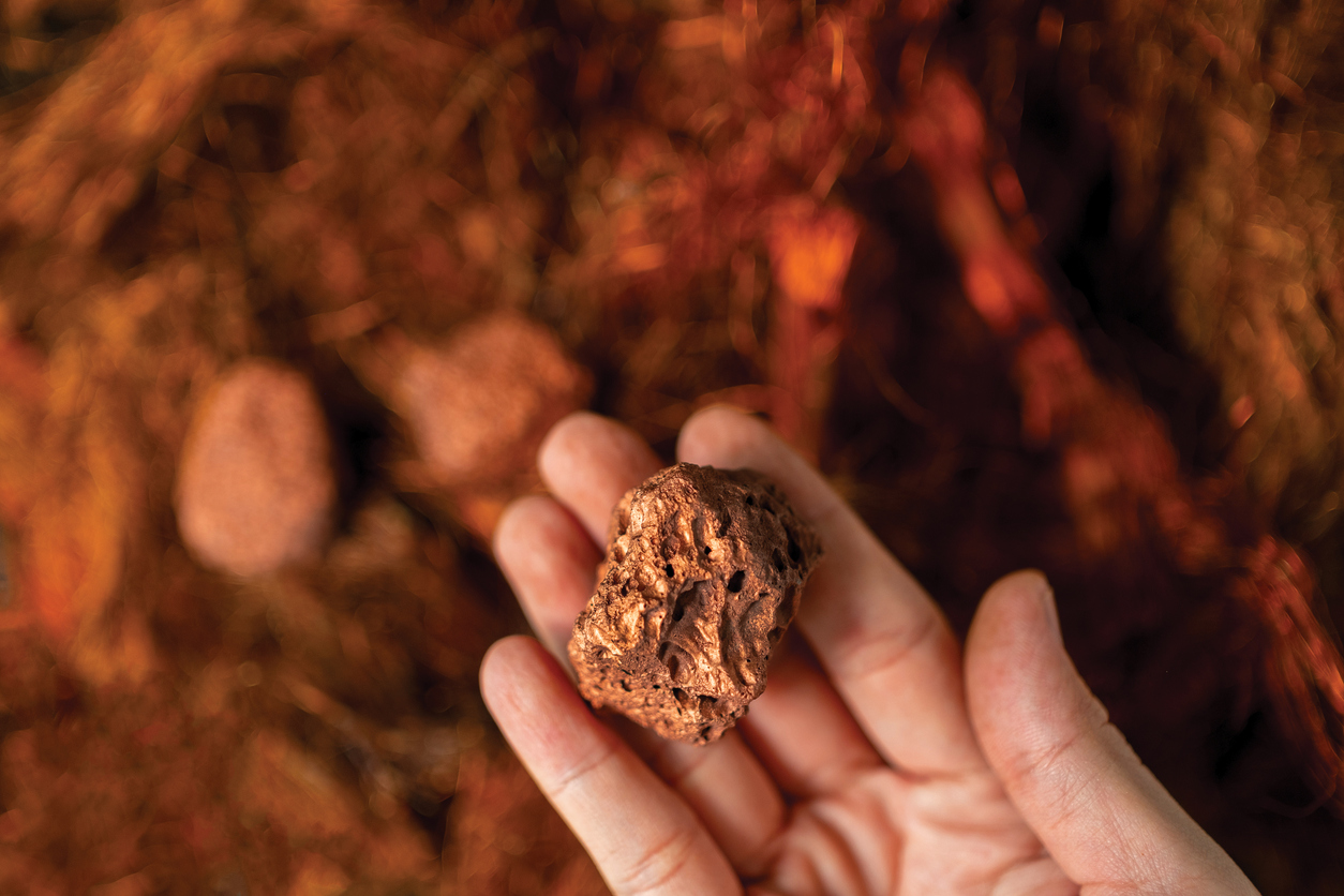 Man's Hand Holding A Piece Of Copper To Examine It For Industrial Use