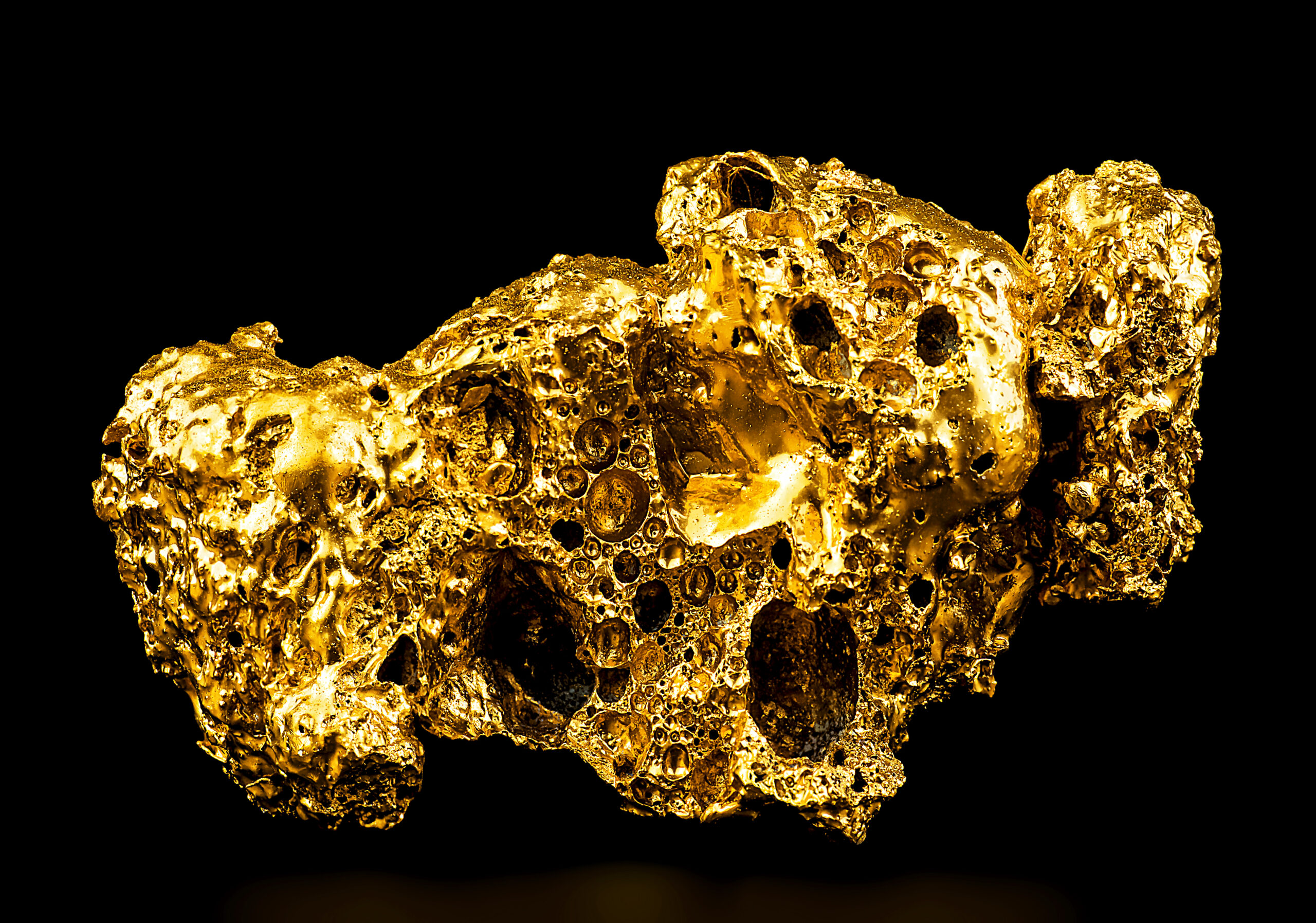 Pure Gold From The Mine On A Black Background. Gold Ore As Finance And Business Concept.